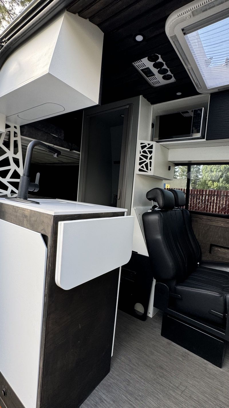 Picture 1/31 of a 144 Sprinter van Sleeps/sits 5 with bathroom & elevator bed  for sale in Big Bear City, California