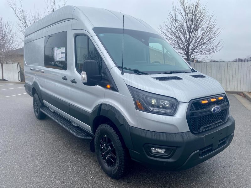 Picture 1/5 of a 2023 NEW Ingot Silver Ford Transit 350 Trail High-Roof AWD for sale in Fayetteville, Arkansas