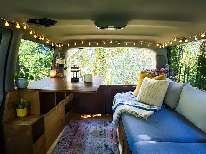 Photo showing a sofa and table in a 1997 AWD Chevy Astro Campervan
