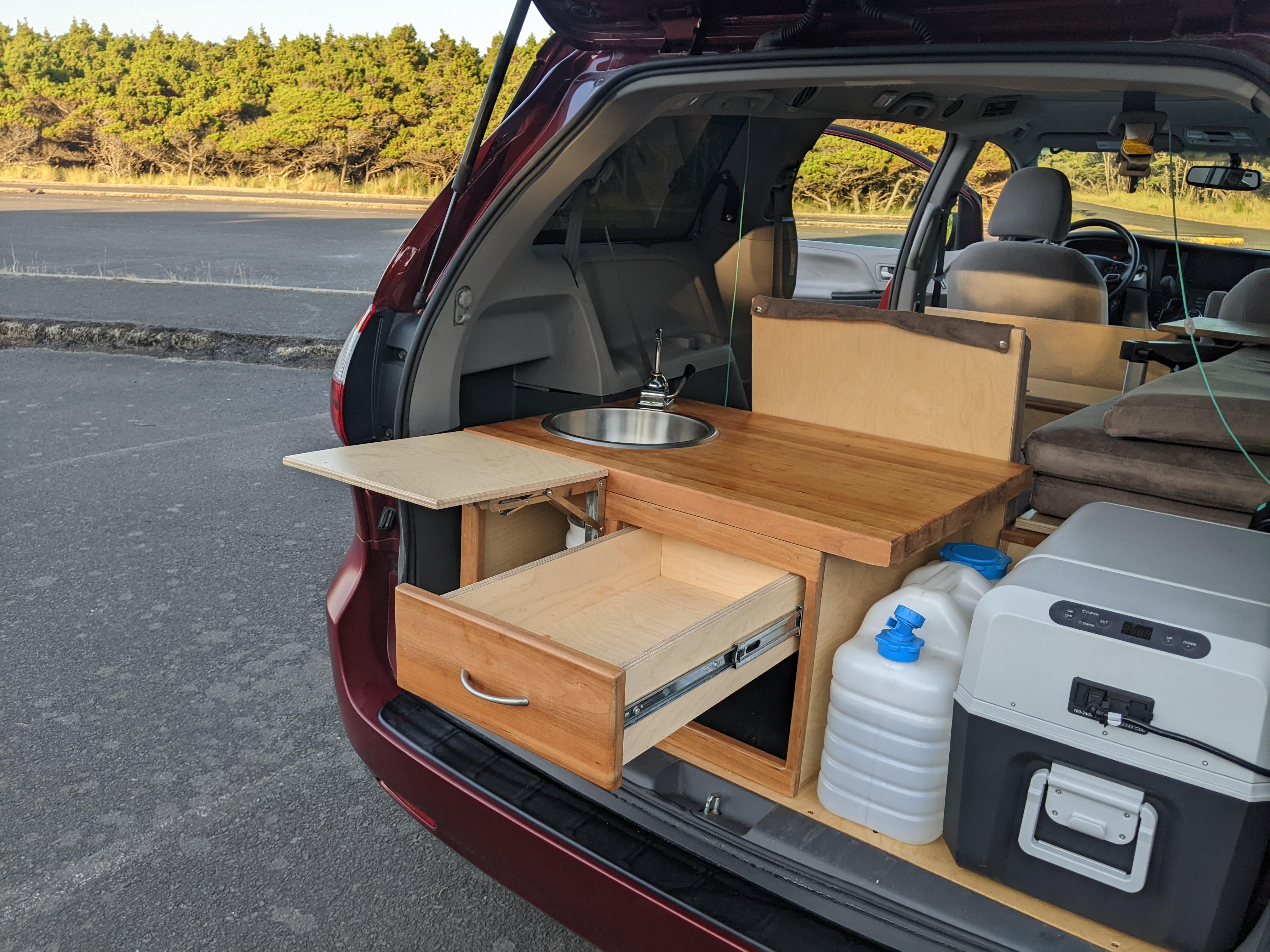Photo showing the rear kitchenette on the outside of a 2017 Toyota Sienna Campervan