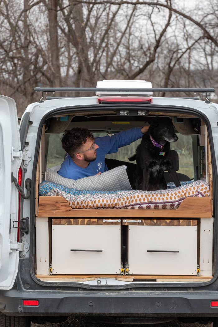 Photo of a man and a dog in a 2018 Ford Transit Connect Campervan